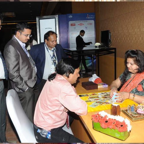 Mallikaa reading cards for guests at an event